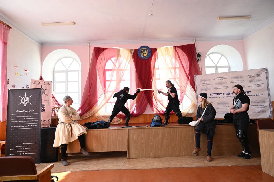 Sparring demonstration on stage at a university history faculty event